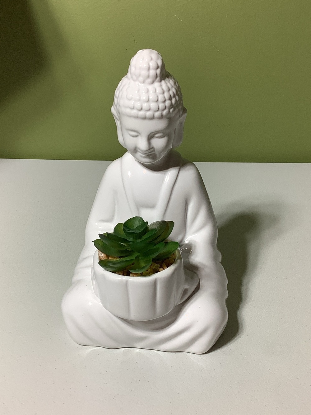 White ceramic Buddha in lotus position